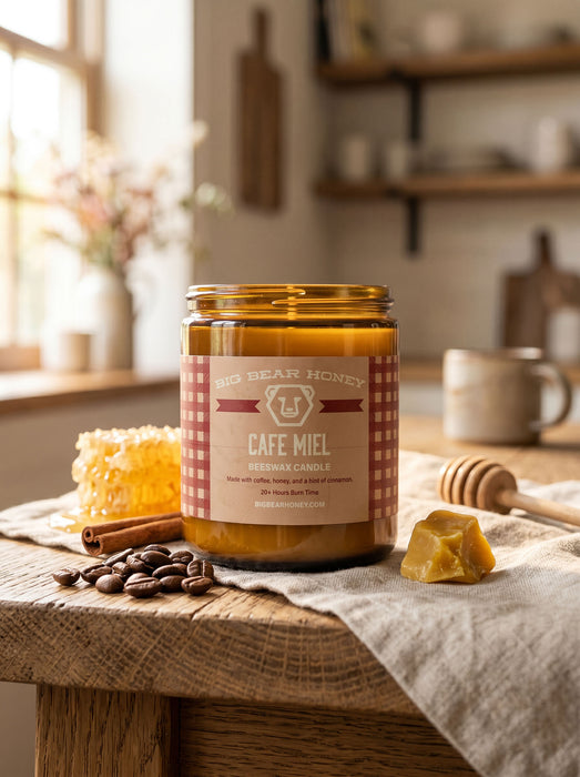 Jar of Big Bear Honey Cafe Miel candle on a wooden table with honeycomb and coffee beans.