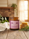 Jar of 'Stress Release' candle on a wooden surface with decorative elements