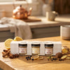 Creamed honey jars in a packaging box on a wooden table with kitchen background