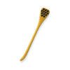 Wooden spoon with honeycomb design on a white background