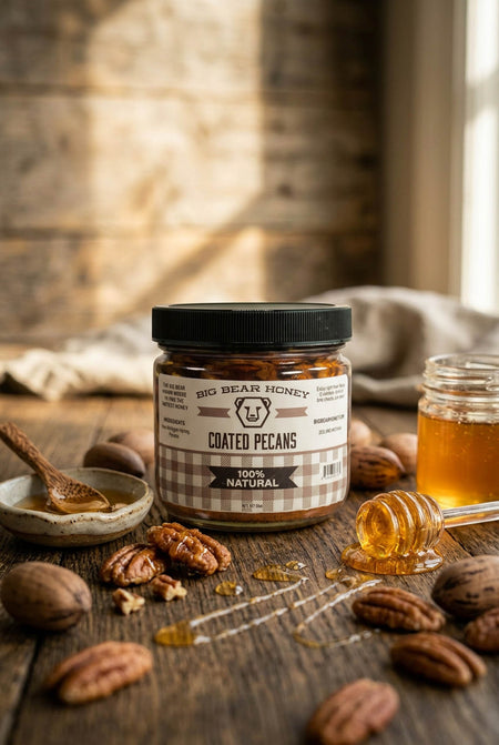Jar of Big Bear Honey Coated Pecans on a wooden surface with honey and pecans.