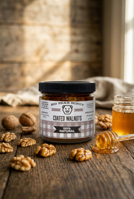 Jar of Big Bear Honey Coated Walnuts on a wooden surface with honey and walnuts.