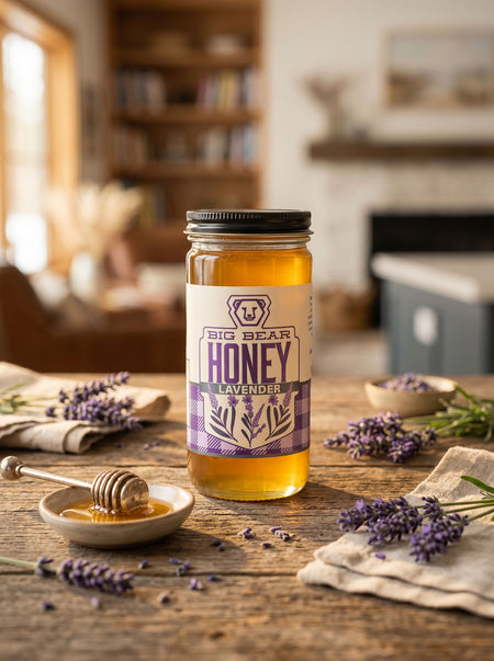 Jar of Big Bear Honey Lavender on a wooden table with lavender flowers.