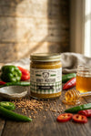 Jar of honey mustard with ingredients on a wooden surface