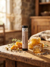 Unscented lip balm  on a wooden table with honeycomb and honey dipper in a rustic setting