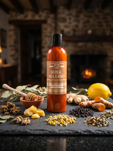 Bottle of Oatmeal, Milk & Honey soap with natural ingredients on a stone surface in front of a fireplace.