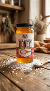 Jar of Big Bear Honey with sea salt on a wooden surface