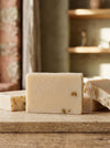 Bar of soap on a wooden surface with a blurred background