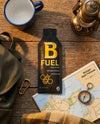 B Fuel raw honey package on a wooden surface with a map, compass, and lantern.
