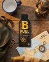 B Fuel raw honey package on a wooden surface with a map, compass, and lantern.