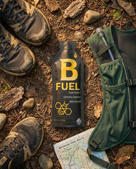 B Fuel bottle on a forest floor with hiking boots and a map