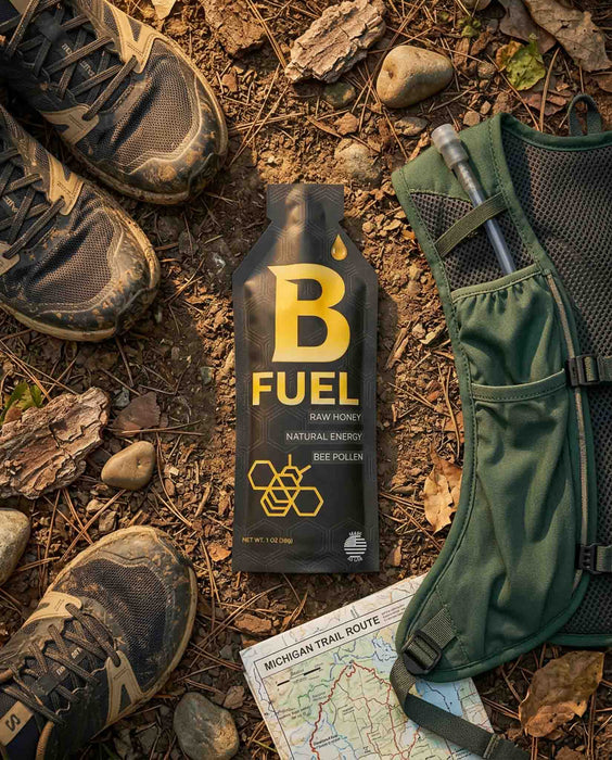 B Fuel bottle on a forest floor with hiking boots and a map
