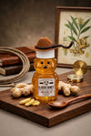 Honey bear with a cowboy hat on a wooden board with ginger and a compass, against a botanical illustration background.