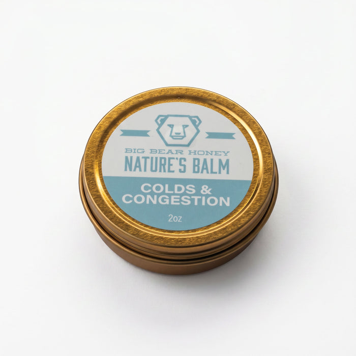 Gold tin labeled 'Nature's Balm' for colds and congestion on a white background