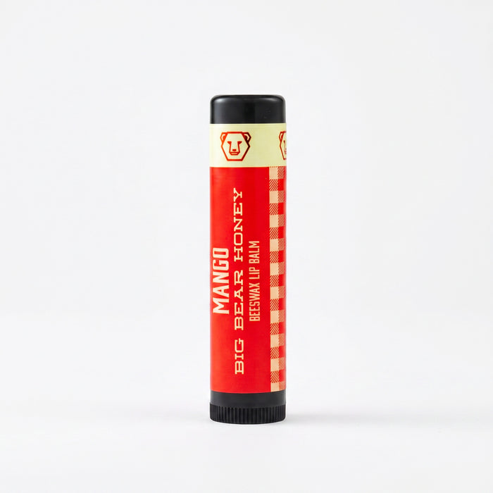 Mango lip balm tube with black cap on a white background
