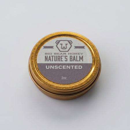 Unscented nature's balm jar with gold lid on a white background