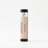 Beeswax lip balm with black cap and white label on a white background