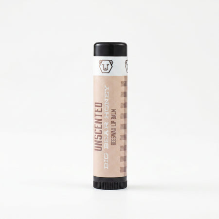 Beeswax lip balm with black cap and white label on a white background