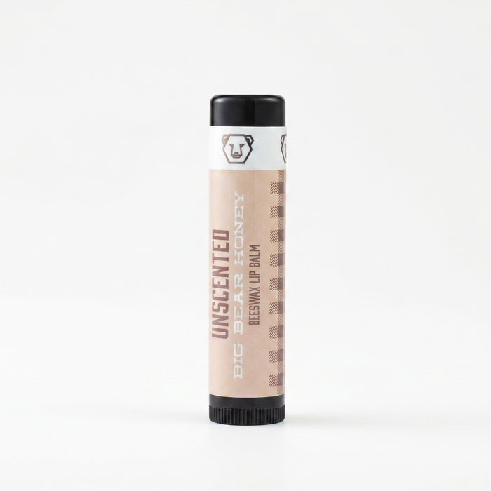 Beeswax lip balm with black cap and white label on a white background